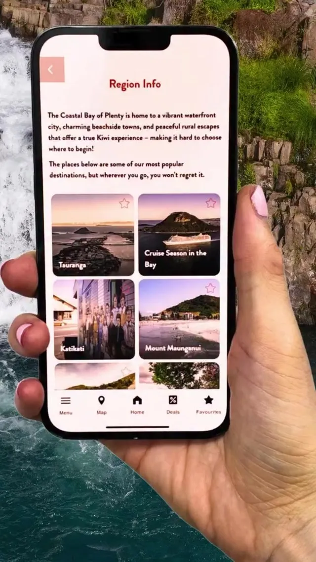 Region Info screen in the app, held up in front of a waterfall