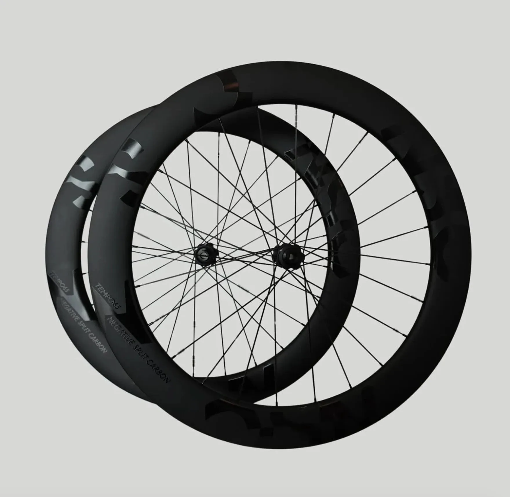 A pair of Negative Split Carbon Tempo 65 deep-rim wheels with tonal black graphics.