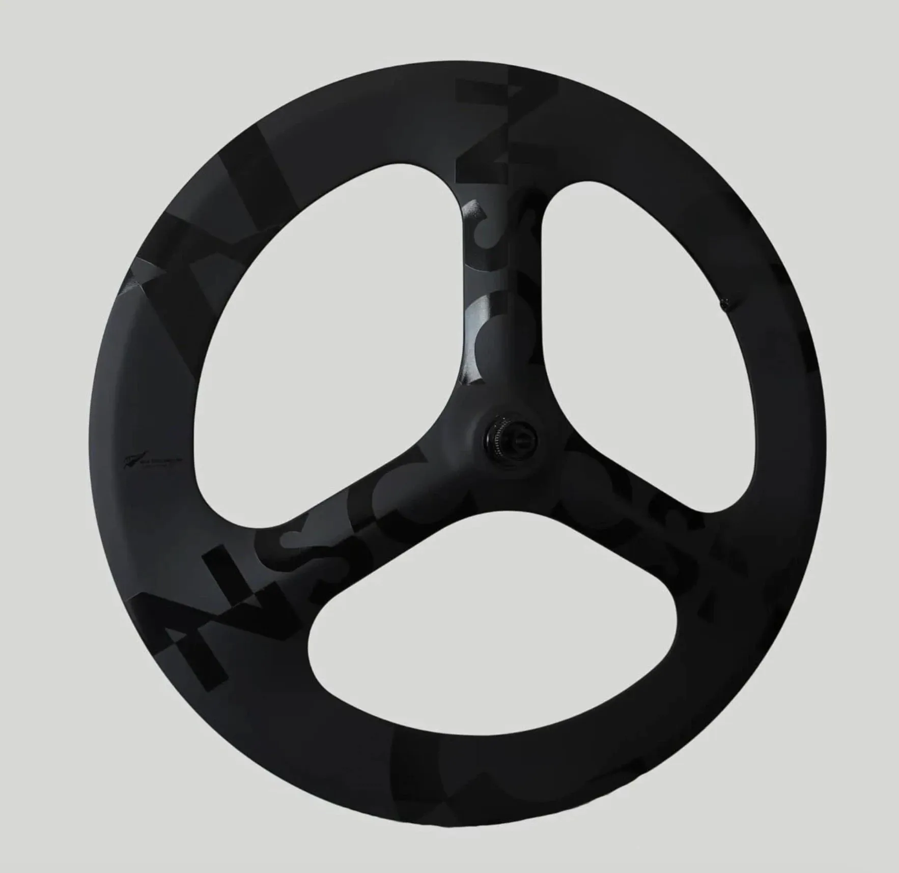 The tri-spoke wheel from a second angle, showing the matte and gloss contrast.
